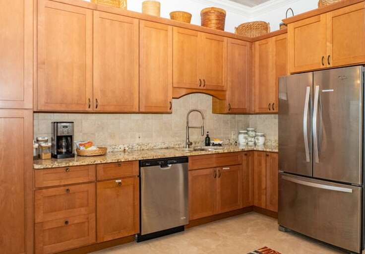 A fully equipped chef's kitchen finished in granite and stainless steel.