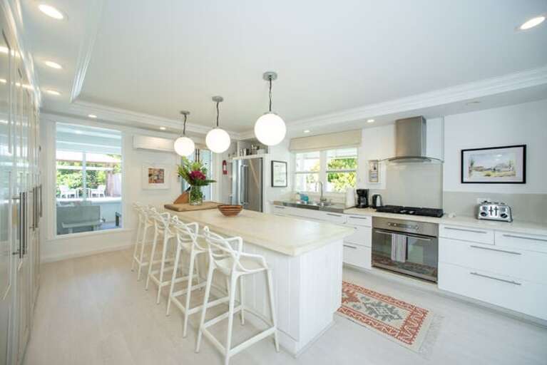 The kitchen is surprisingly expansive and modern for a historic home, thoughtfully updated with contemporary appliances.