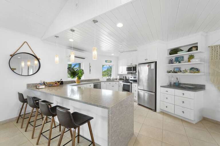 Luxurious modern kitchen finished in quartz and stainless steel.