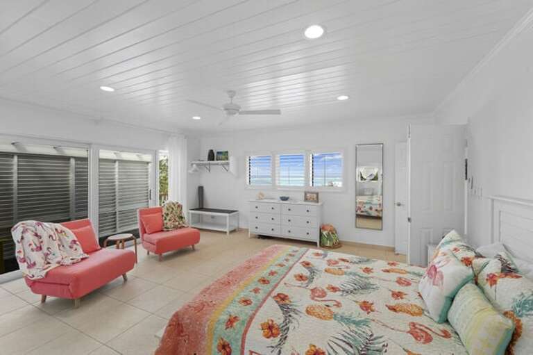 Master bedroom with ocean views.  The pink chairs can fold out into twin-sized beds.
