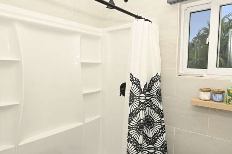 Bath with walk-in shower.