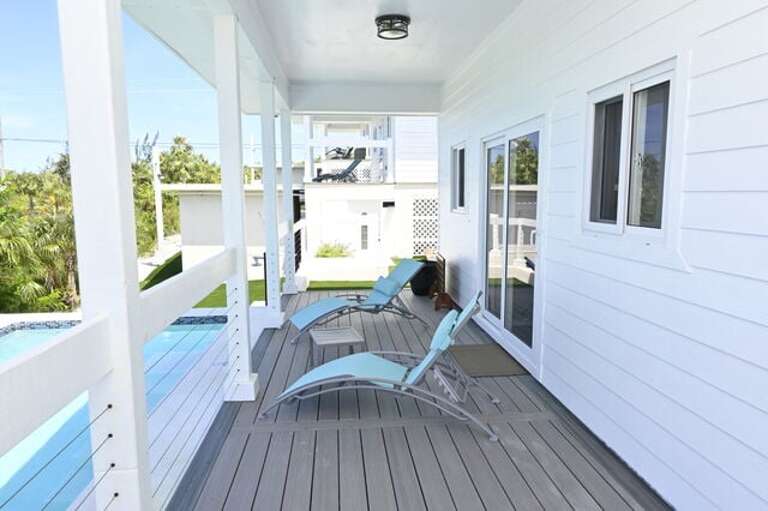 Covered porch with lounge chairs.