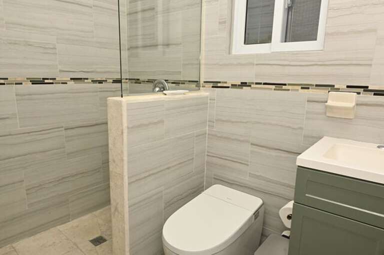Bath with walk-in shower.