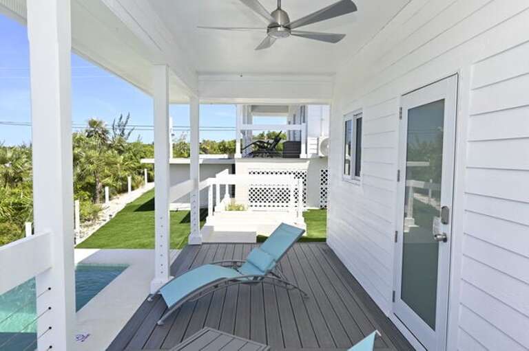 Covered porch with lounge chairs.
