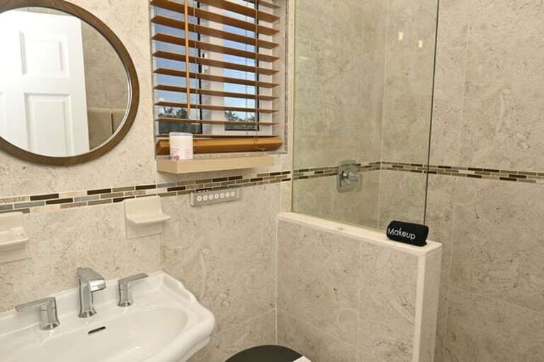 Bath with walk-in shower.