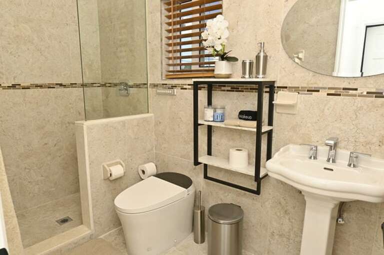 Bath with walk-in shower.