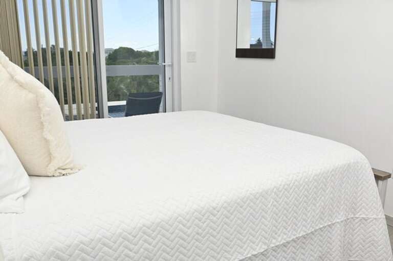 Each bedroom has a queen bed, a 65-inch wall-mounted flat-screen TV.