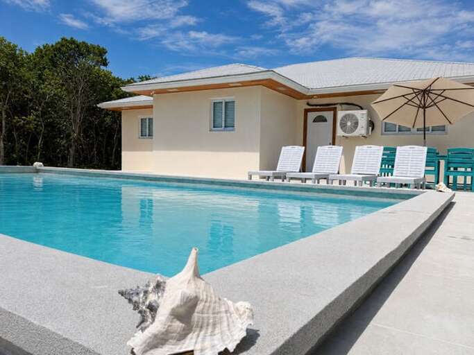 Our pool with deck and lounge chairs.