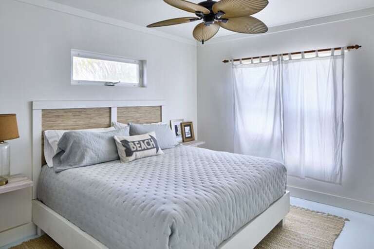 King bedroom with soft coastal linens.