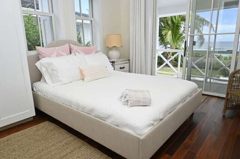 Cottage bedroom #2 with a queen bed, en-suite full bath, and an ocean view.