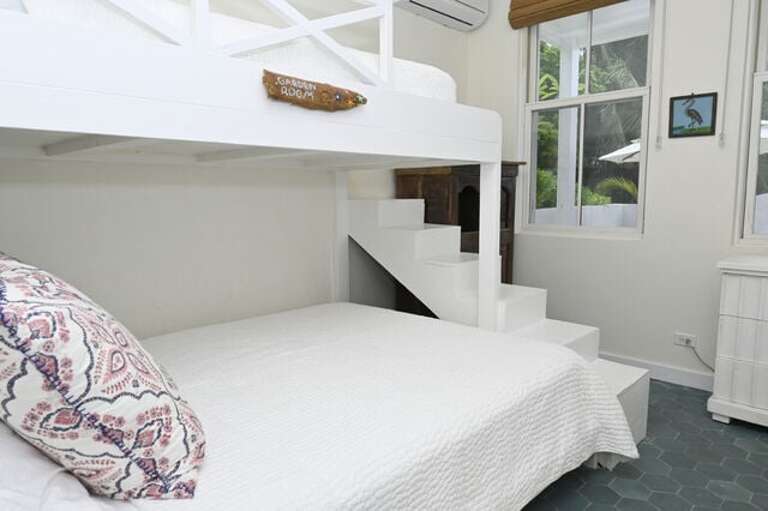 Cottage bunk room with a twin-on-queen bunk bed and an ensuite full bath.