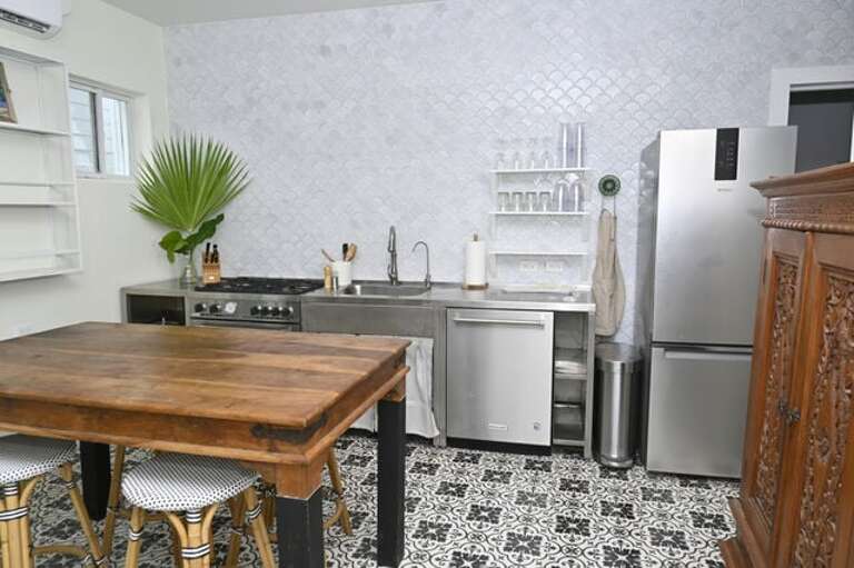 Cottage kitchen with a Bertazzoni range, refrigerator, dishwasher, and RO-filtered drinking water.