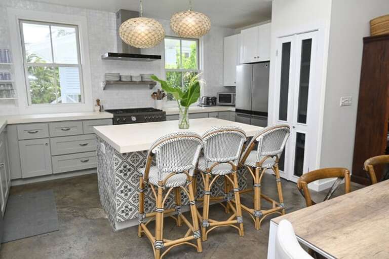 Luxurious island kitchen with ocean views, finished in concrete and stainless steel.