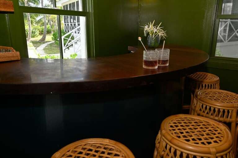 The Snug, connected to the Casita via an elevated deck, is a cozy bar cottage, a Bahamian spin on a classic speakeasy.
