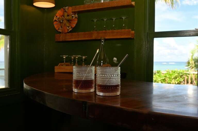 The Snug features a built-in bar with a sink and fridge, all overlooking the hot tub.