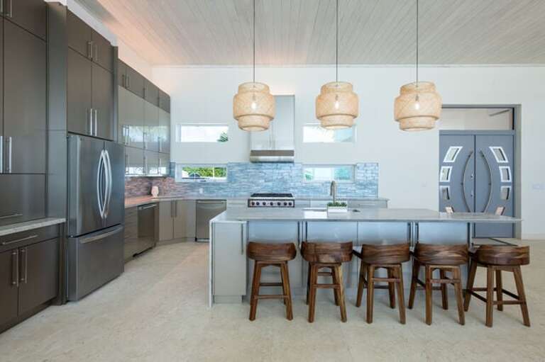 Luxurious island kitchen finished in quartz and stainless steel.
