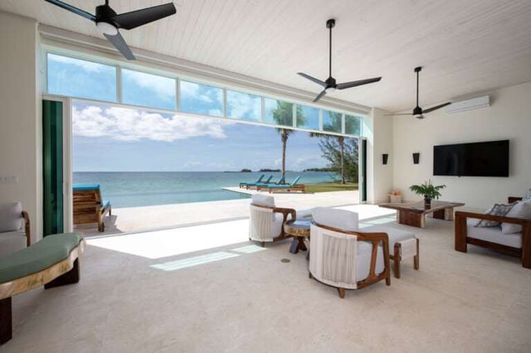 Great room with glass wall retracted to let in the sea breeze.