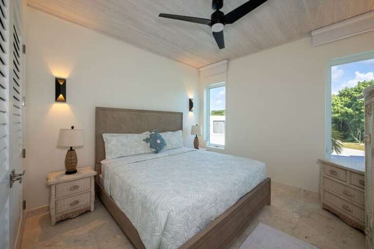 Guest cottage second bedroom with garden view.