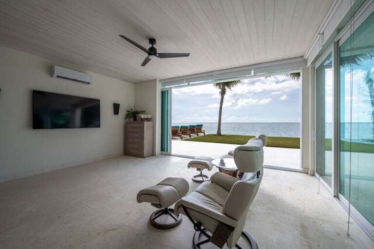 The TV room with a retractable wall of glass overlooking the Caribbean.  This room has a queen sofa bed (not yet landed) and can be used as the 4th bedroom in the main house.