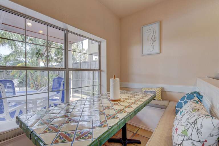 Breakfast table, with bench seating, overlooks the backyard and pool! Breakfast table, with bench seating, overlooks the backyard and pool!