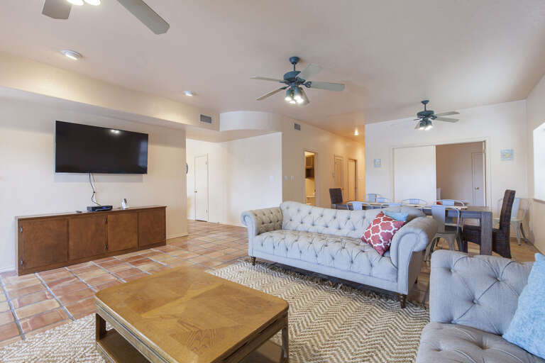 Living room features a flat screen TV that can be seen from dining room as well Living room features a flat screen TV that can be seen from dining room as well