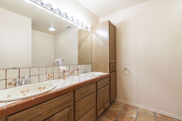 Shared guest bathroom is located on the second floor and is equipped with double vanity and a bathtub and shower combination Shared guest bathroom is located on the second floor and is equipped with double vanity and a bathtub and shower combination
