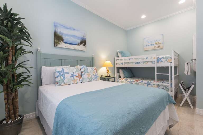 Downstairs bedroom #1 with a queen bed and twin bunk beds!