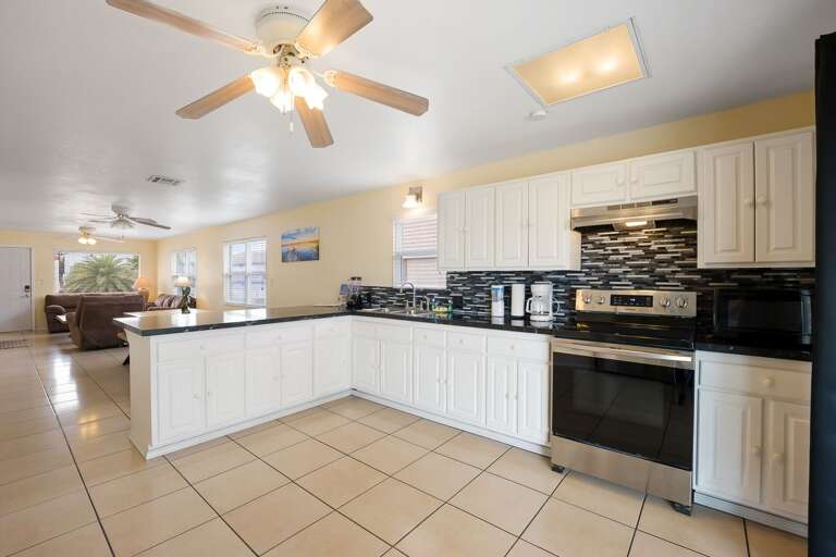 Large kitchen with stainless steel appliances.