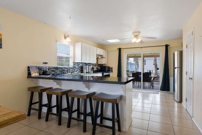 Open concept kitchen features additional seating at the bar for 4 guests.