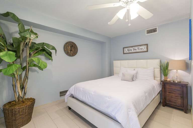 4th bedroom with Queen bed and back patio/pool access. Located on the ground floor.