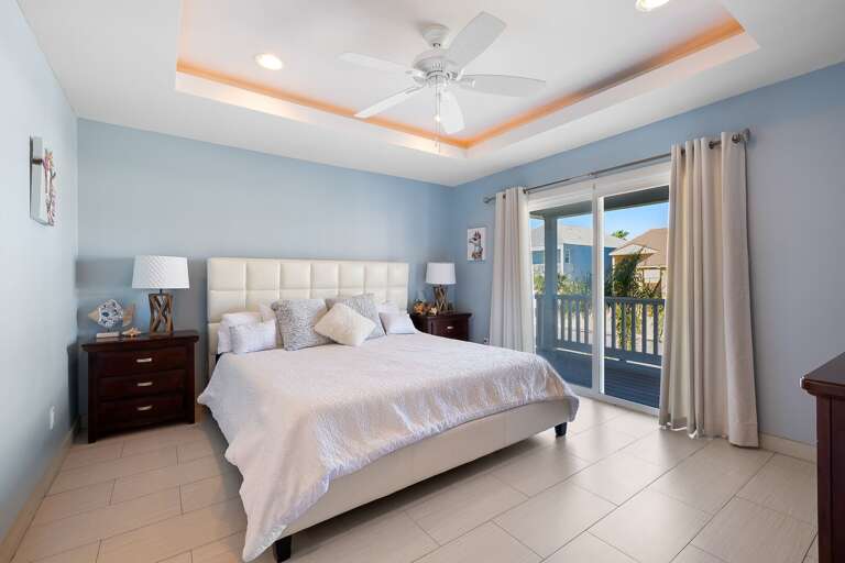 Master bedroom with king size bed, balcony access & private master bathroom.