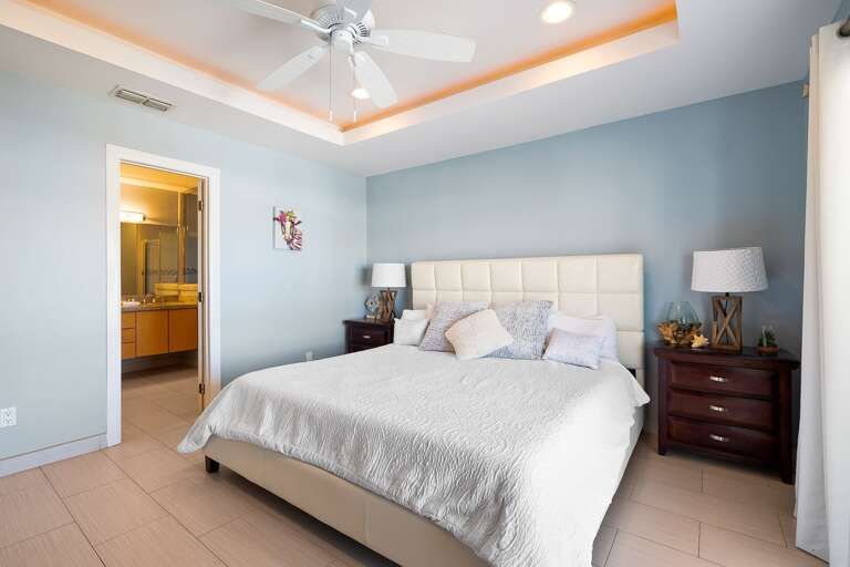 Master bedroom with king size bed, flat screen TV, balcony access & private master bathroom.