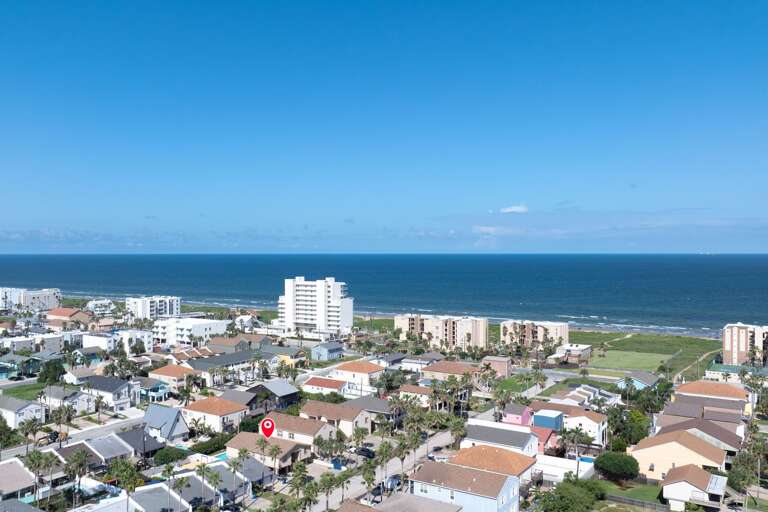 Seaside Settlement Sprawls Beside Brilliant Blue Bay