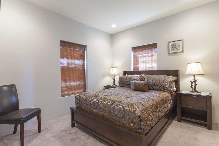Bedroom 2 features a queen bed and flat screen TV.