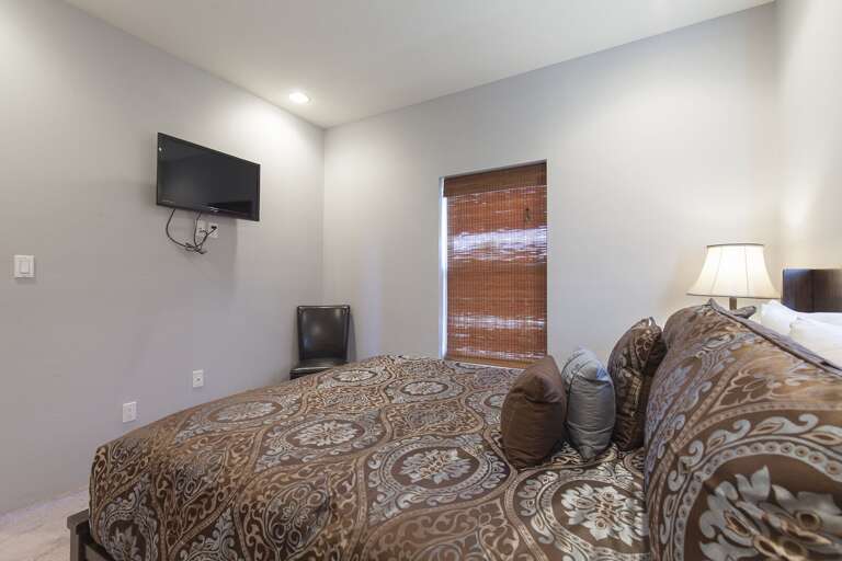Bedroom 2 features a queen bed and flat screen TV.