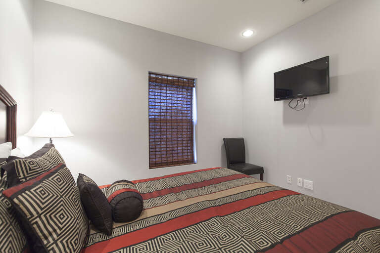Bedroom 3 features a queen bed and flat screen TV.