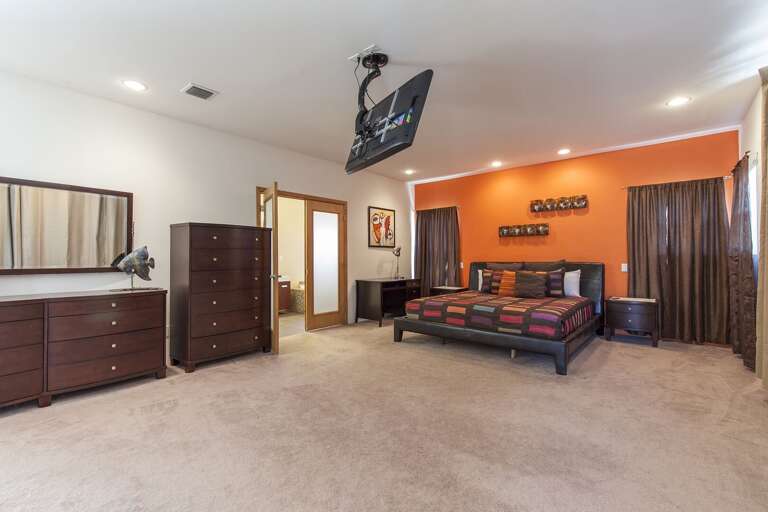 Grand Master Suite with a king bed, twin day bed, and mounted flat screen TV!