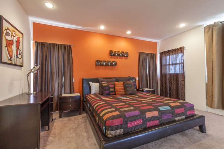 Grand Master Suite with a king bed, twin day bed, and mounted flat screen TV!