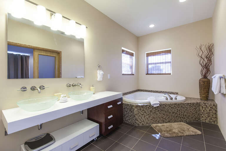 Private master bathroom features a large soaking tub.