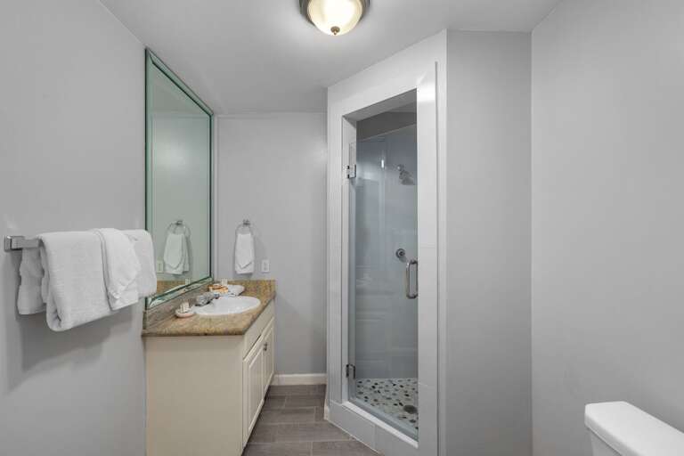 1st floor bathroom with newly remodeled walk in shower and large vanity mirror