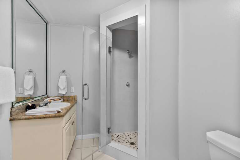 1st floor bathroom with newly remodeled walk in shower and large vanity mirror