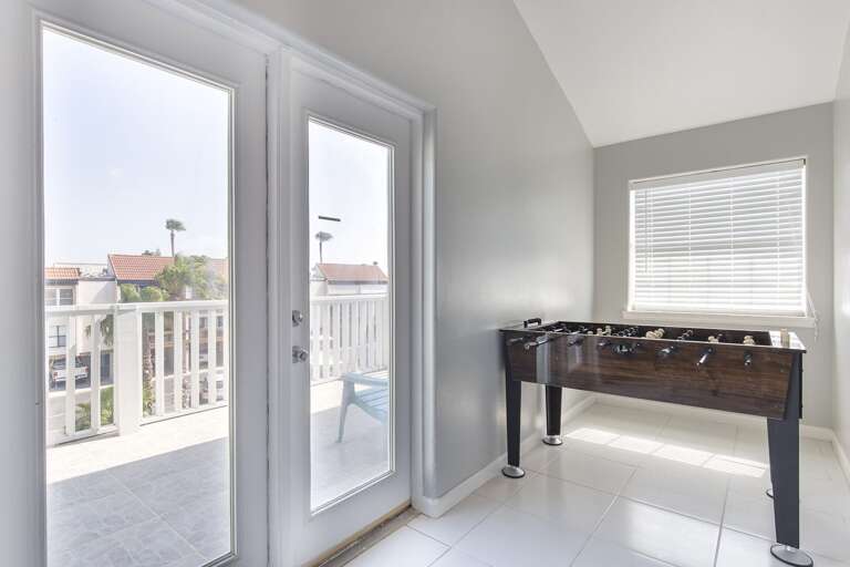 3rd floor sun room/game room has access to 3rd floor south side balcony (Double Futon, Foosball Table)