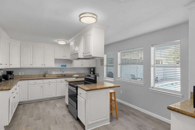Large kitchen with additional bar seating and stainless steel appliances