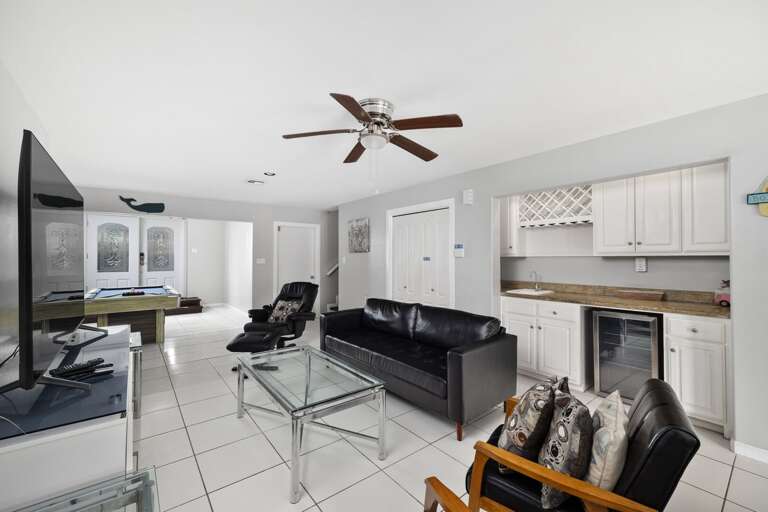 Pool table and living room. Plenty of game activities for the guests (small ping pong table in the garage and foosball table in 3rd floor sunroom)