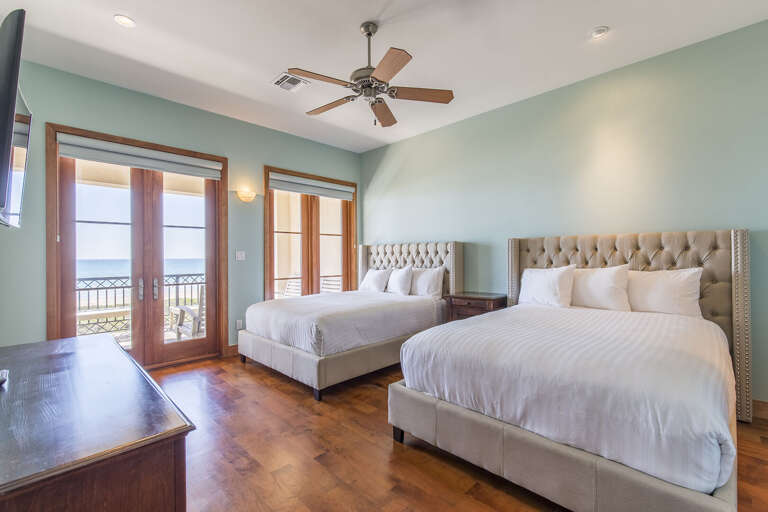 Guest room with queen beds, flat screen tv,  and ocean views!