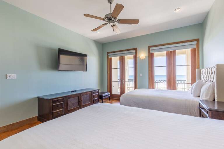 Guest room with queen beds, flat screen tv,  and ocean views!