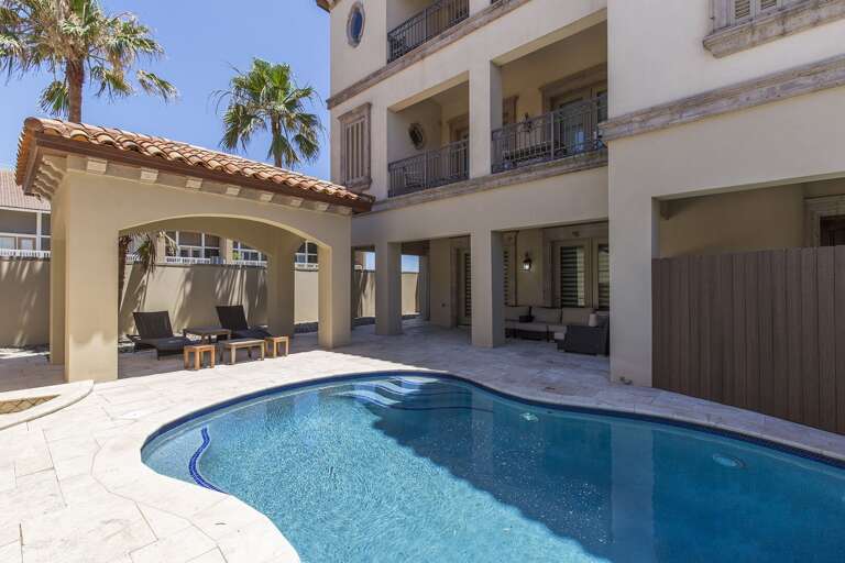 Private pool is surrounded by a privacy gate and is located in between the garage and the property.