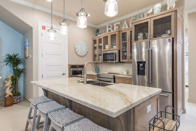 Fully stocked kitchen with stainless steel appliances including two microwaves, 2 ovens, and equipped with a gorgeous bar.