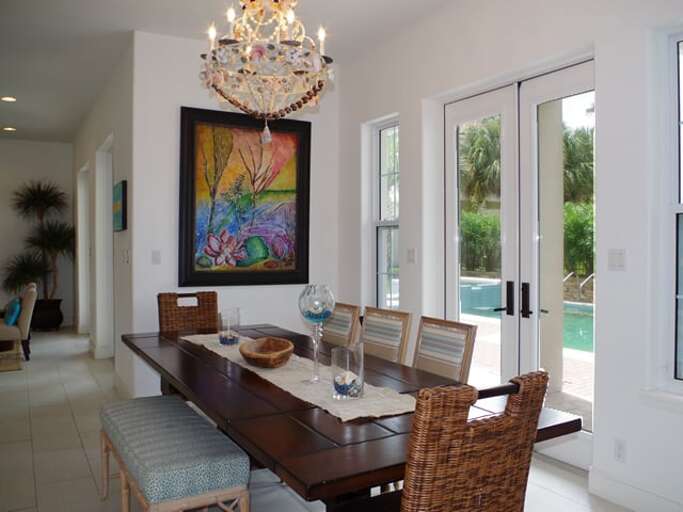 A beautiful set of french doors open up from the dining area to the private pool