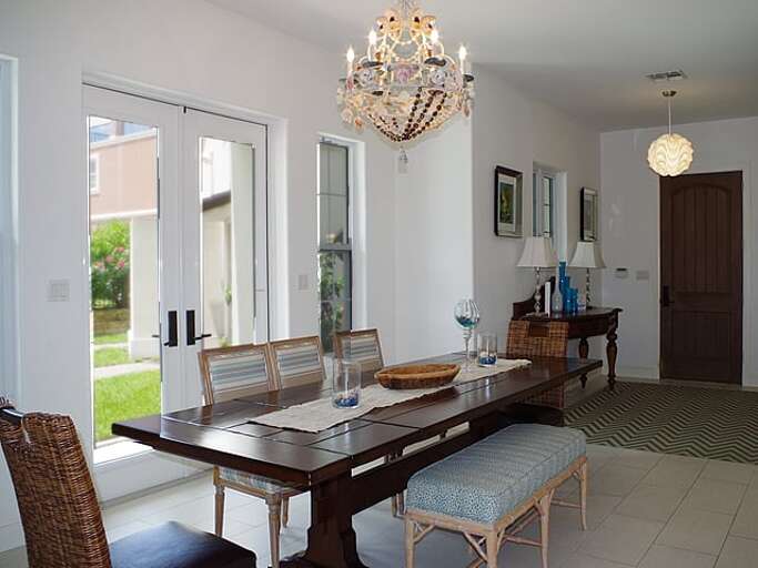 Dining table seats seven comfortably, with additional seating for 4 at the bar